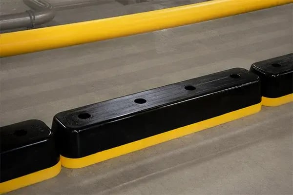 a-safe step guard safety curb shown on warehouse floor