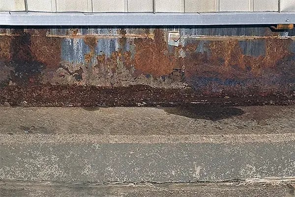 corroded tank chime angle is revealed under insulation panels