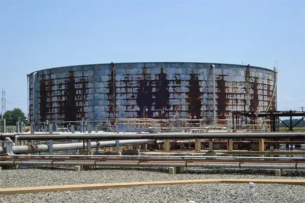 metal storage tank wall damaged by hidden corrosion under insulation
