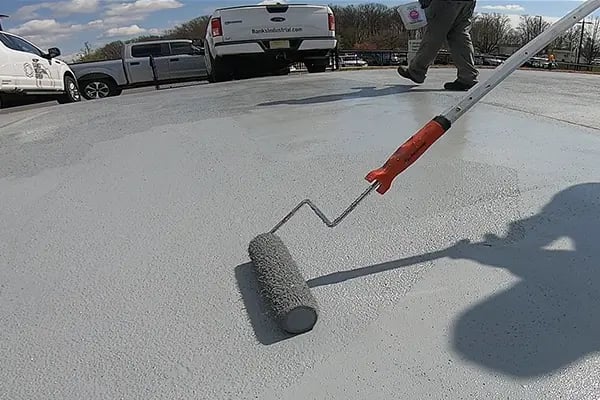 helipad concrete protective coating being applied by roller
