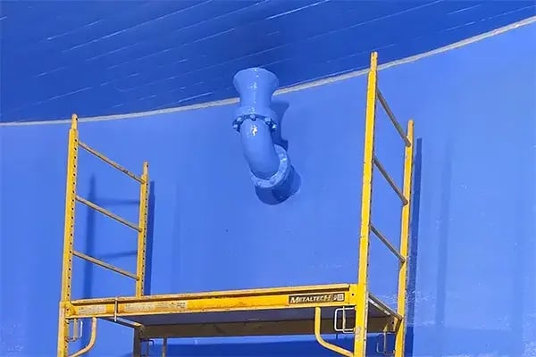 underground water storage tank pipe restoration and concrete seam seal shown with work scaffold below