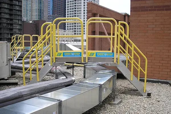 rooftop crossover stairs provide safe access over hvac ducts and piping on hotel roof