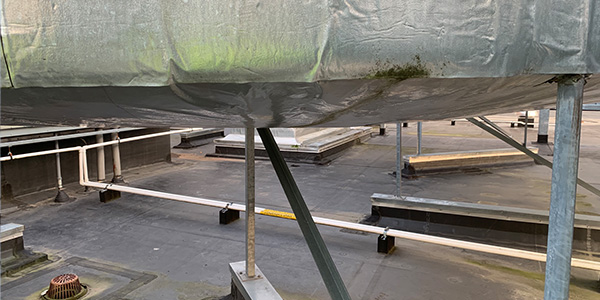 water saturated hvac insulation wrap sags like a wet diaper under sheet metal duct