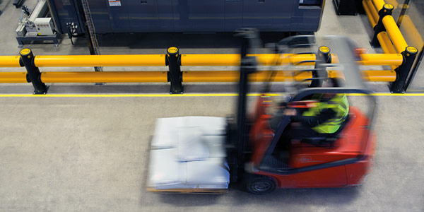 forklift moves past flexible safety barriers