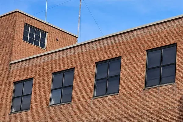 building elevation showing final capstone coating and brick pointing