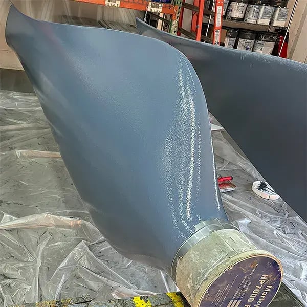 cooling tower fan blade with first layer of belzona protective coating