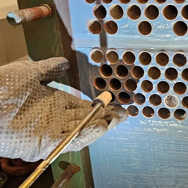 corks are removed from heat exchanger tubes by using a cork screw