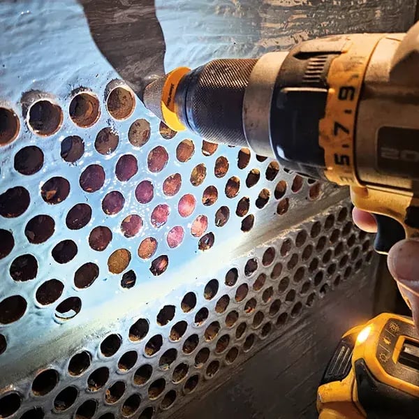 tube sheet exchanger tubes are chamfered with a grinding drill to remove residual coating