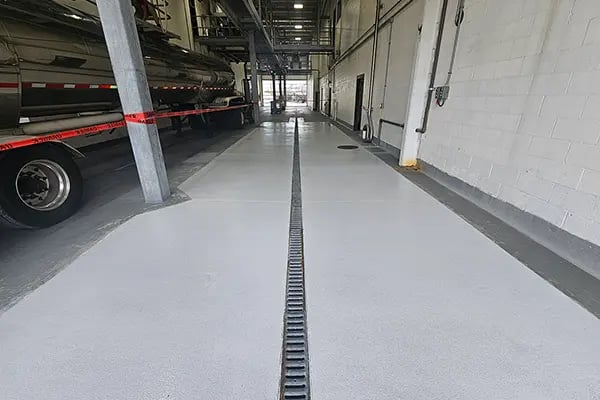 anti-slip coating around drain area in truck maintenance bay