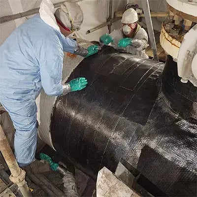 banks industrial group field technicians apply belzona superwrap 2 repair system around a broken beetle pipe