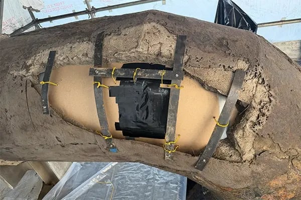 pressed paperboard backer used for epoxy mortar repair of concrete lined pipe sidewall