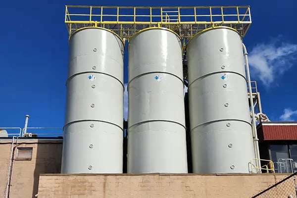 external protective coating freshly applied to three silo tanks