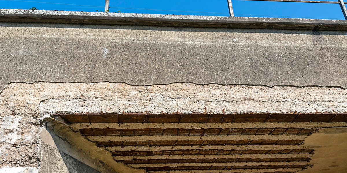 Corroded rebar causes concrete spalling on a railroad overpass