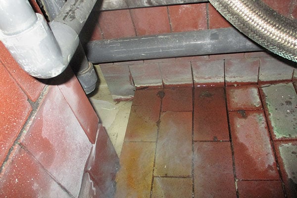 missing acid brick grout allows chemicals to seep underneath and damage floor