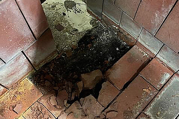 floor damaged below acid brick due to missing