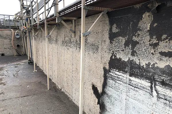 failed coating and deteriorated concrete underneath