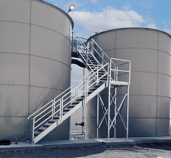 exterior roof access stairs provide safe travel for maintenance workers at a tank farm