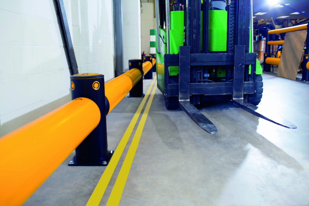 flexible guard rail protects warehouse wall from forklift traffic