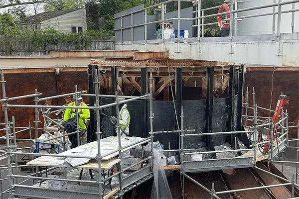 corroded feed well superwrap repair work in process within large water treatment clarifier