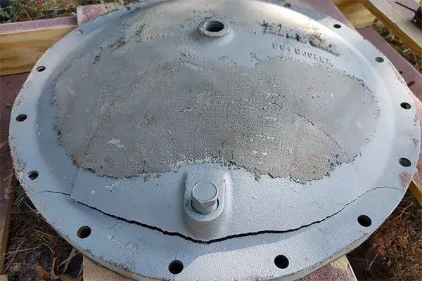 chiller end cap with large cracked in the metal