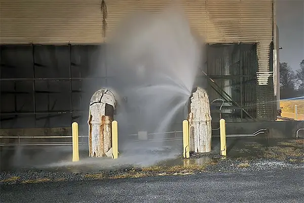 water sprays from a power plant cooling tower pipe that burst during cold weather