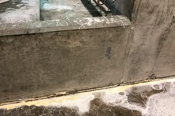 caustic damage to containment joint seams