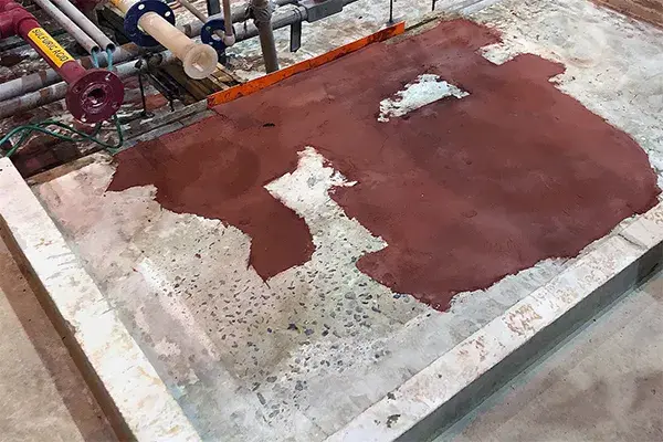 concrete repair patch in sulfuric acid containment area