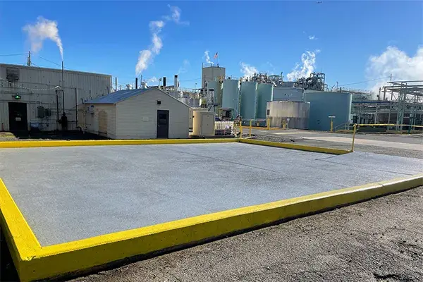 restored concrete drum pad with chemical resistant concrete coating at chemical plant