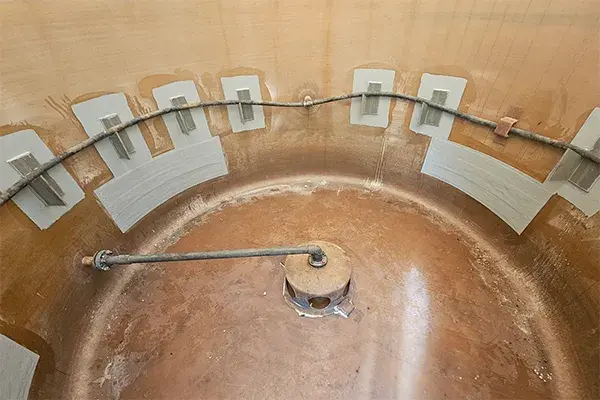 fiberglass storage tank showing internal damage repairs and brackets