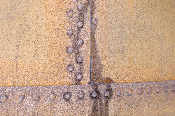 fluid leak from riveted seam of tank plates